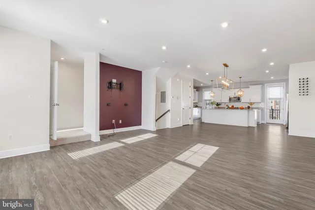 a view of a living room kitchen with a sink and a large window