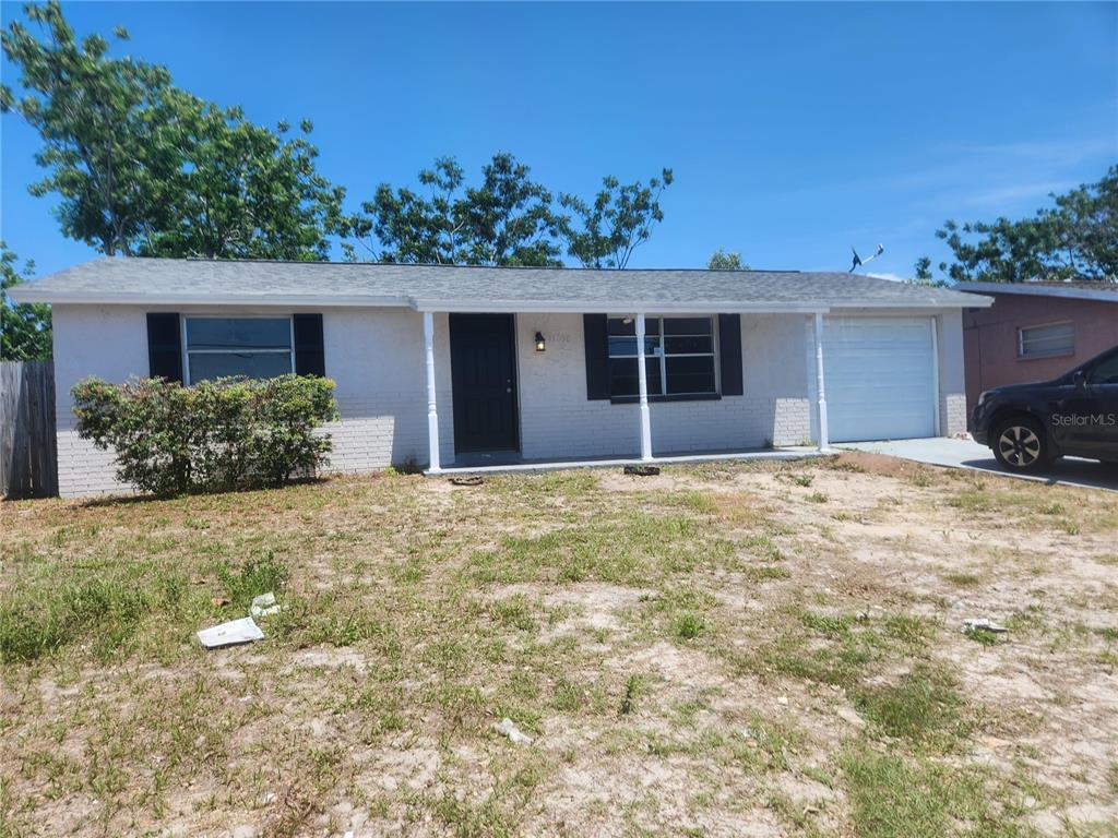 11608 Zimmerman Road Port Richey, FL 34668 - Photo 1 of 1 front view of a house with a yard