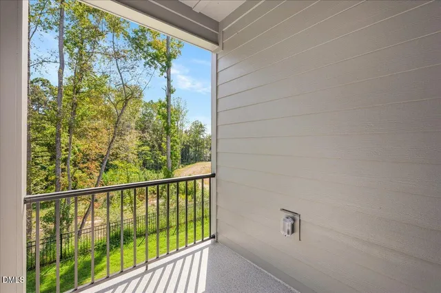 a bedroom with a bed and a potted plant