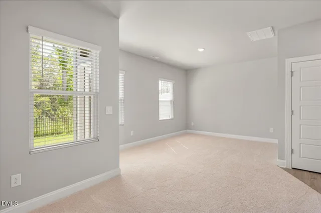 a view of a house with a yard and a large window