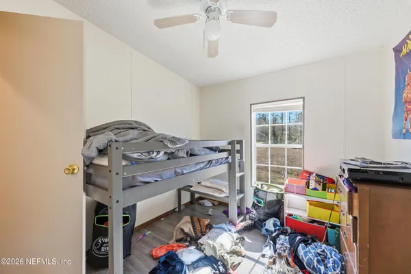 a bed room with furniture and wooden floor