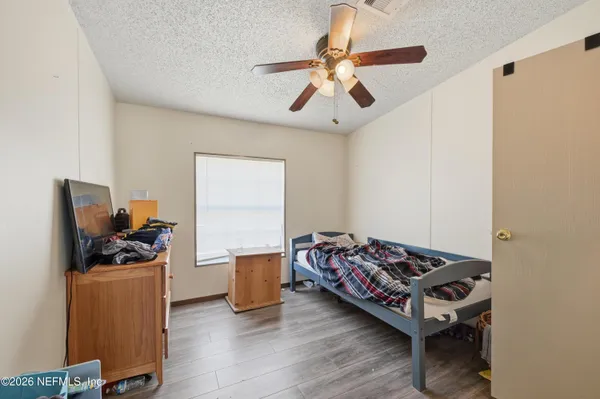 a bedroom with a bed and a flat tv screen