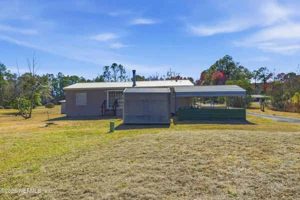 a swimming pool with outdoor seating and yard