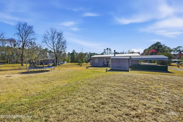 a backyard of a house with lots of green space