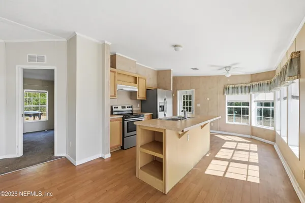 a kitchen with white cabinets and appliances