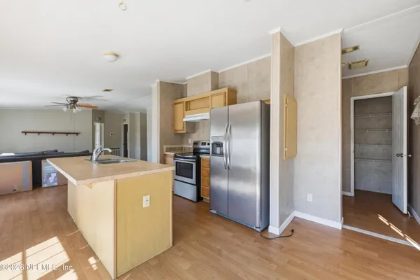 a kitchen with stainless steel appliances granite countertop a refrigerator and a sink