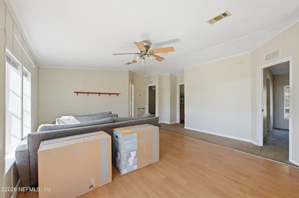 a kitchen with stainless steel appliances granite countertop a sink a stove a dining table and chairs