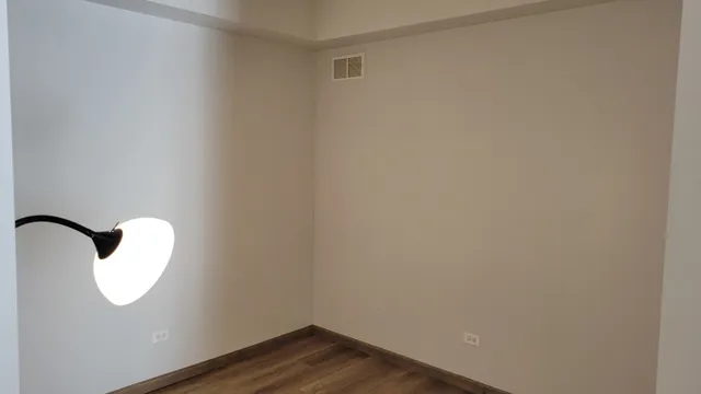 an empty room with wooden floor