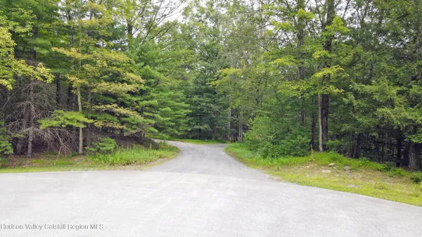 a backyard of a house with lots of green space and fountain