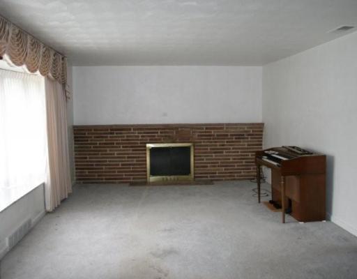 603 Ravencrest Road Pittsburgh, PA 15215 - Photo 3 of 10 Living Room. Living Room with fireplace. Hardwood under carpet.
