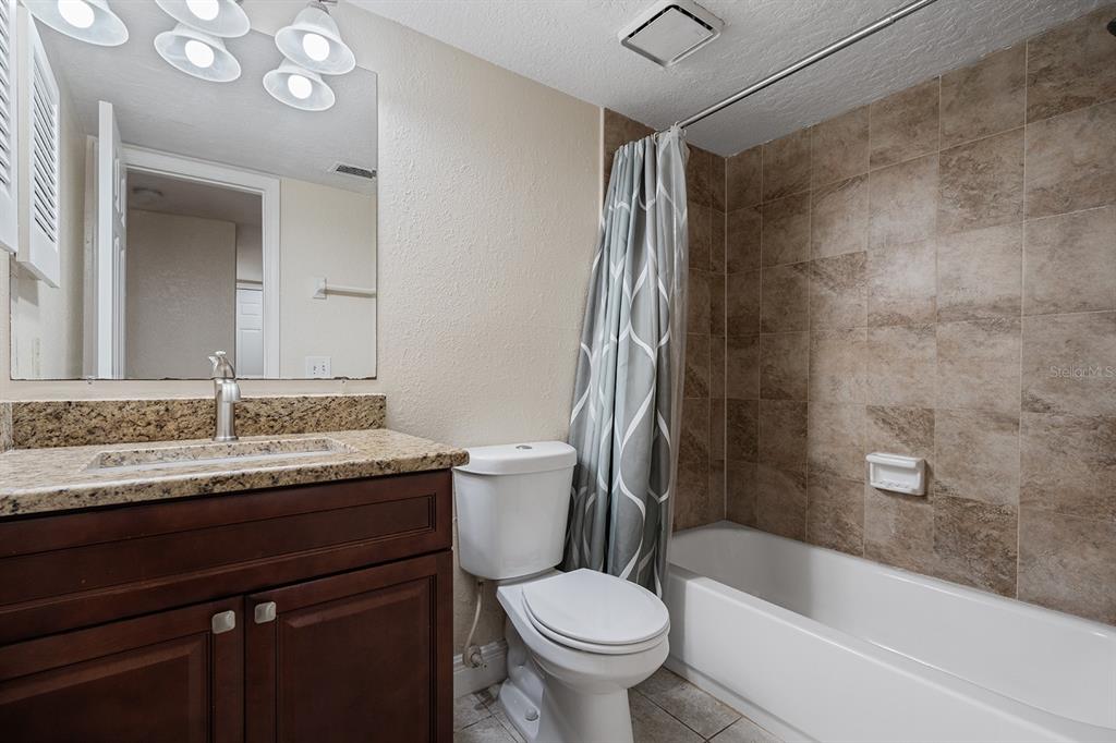 940 Douglas Avenue, Unit 158 Altamonte Springs, FL 32714 - Photo 14 of 23 a bathroom with a granite countertop sink toilet and shower