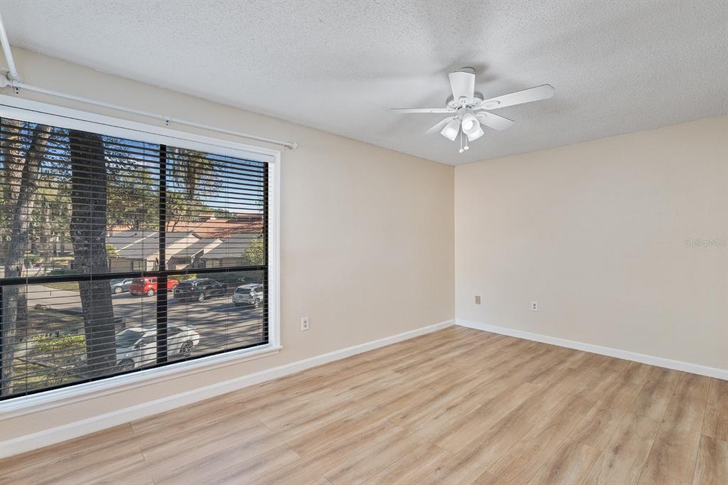 940 Douglas Avenue, Unit 158 Altamonte Springs, FL 32714 - Photo 17 of 23 an empty room with wooden floor fan and windows