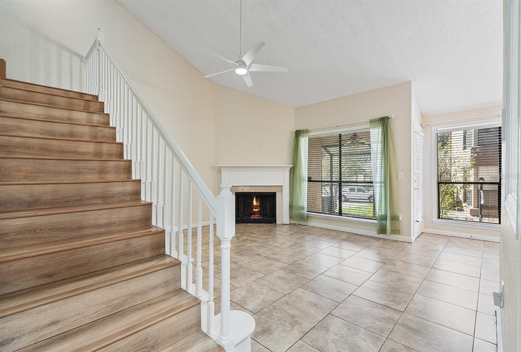 940 Douglas Avenue, Unit 158 Altamonte Springs, FL 32714 - Photo 5 of 23 a view of an empty room with wooden floor and fireplace