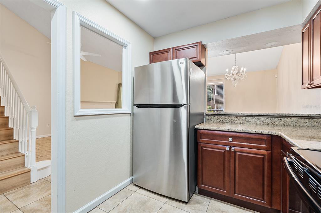 940 Douglas Avenue, Unit 158 Altamonte Springs, FL 32714 - Photo 8 of 23 a kitchen with stainless steel appliances granite countertop a refrigerator and a sink