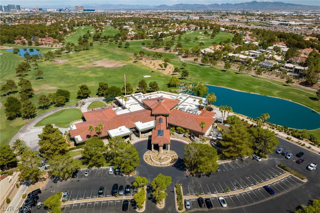 20 Innisbrook Avenue Las Vegas, NV 89113 - Photo 22 of 39 An aerial panorama reveals a magnificent golf course and clubhouse set against a vibrant blue lake.