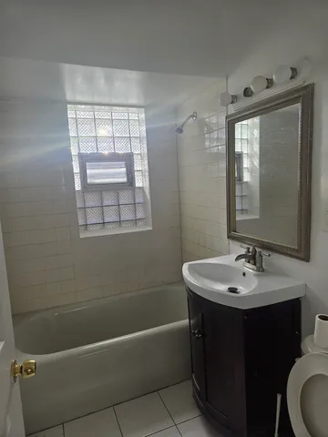 a bathroom with a toilet a sink and mirror