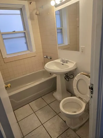 a view of a room with wooden floor and a window