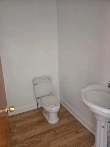 a white toilet sitting next to a bathroom sink