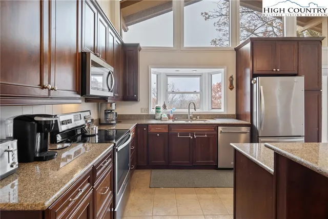 a bedroom with a bed couch and a flat tv screen