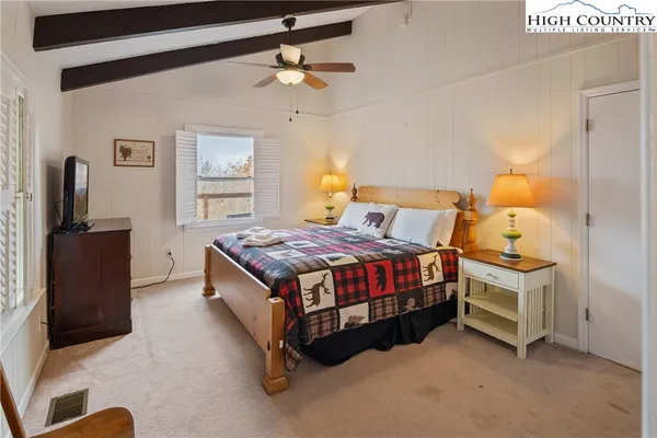 a bedroom with bed and a chandelier