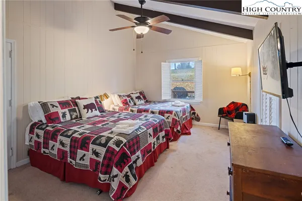 a spacious bedroom with a bed and window