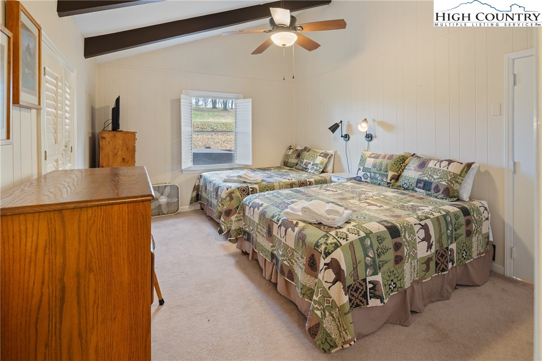 501 St Andrews Road Beech Mountain, NC 28604 - Photo 16 of 46 a spacious bedroom with a bed and window