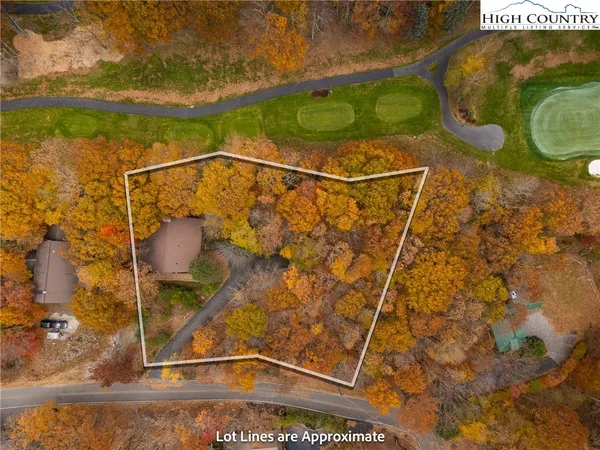 a dining room with furniture a chandelier and wooden floor