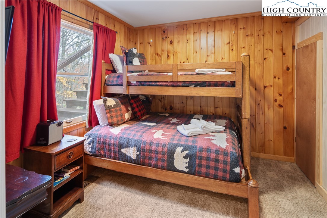 501 St Andrews Road Beech Mountain, NC 28604 - Photo 25 of 46 a bedroom with a bed and window