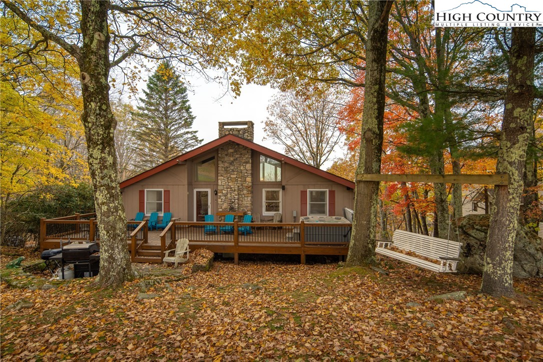 501 St Andrews Road Beech Mountain, NC 28604 - Photo 31 of 46 a view of a house with a yard and sitting area