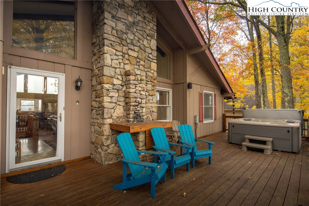 501 St Andrews Road Beech Mountain, NC 28604 - Photo 34 of 46 a view of a patio with table and chairs and wooden floor