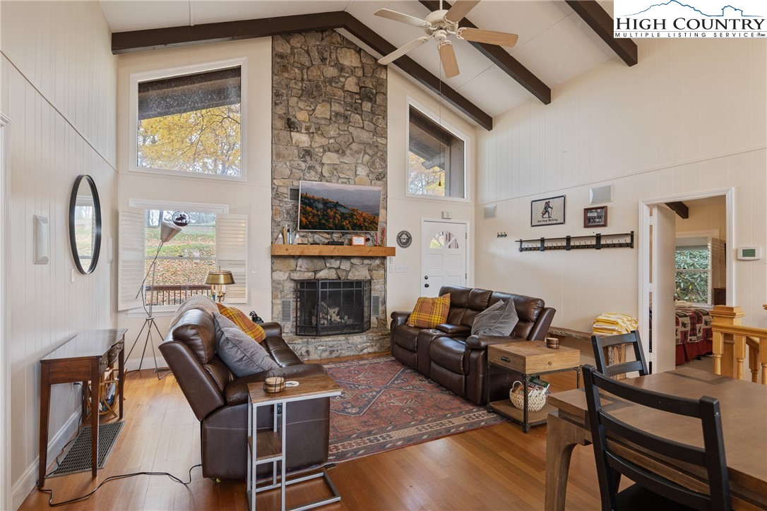 501 St Andrews Road Beech Mountain, NC 28604 - Photo 6 of 46 a living room with furniture a flat screen tv and a fireplace