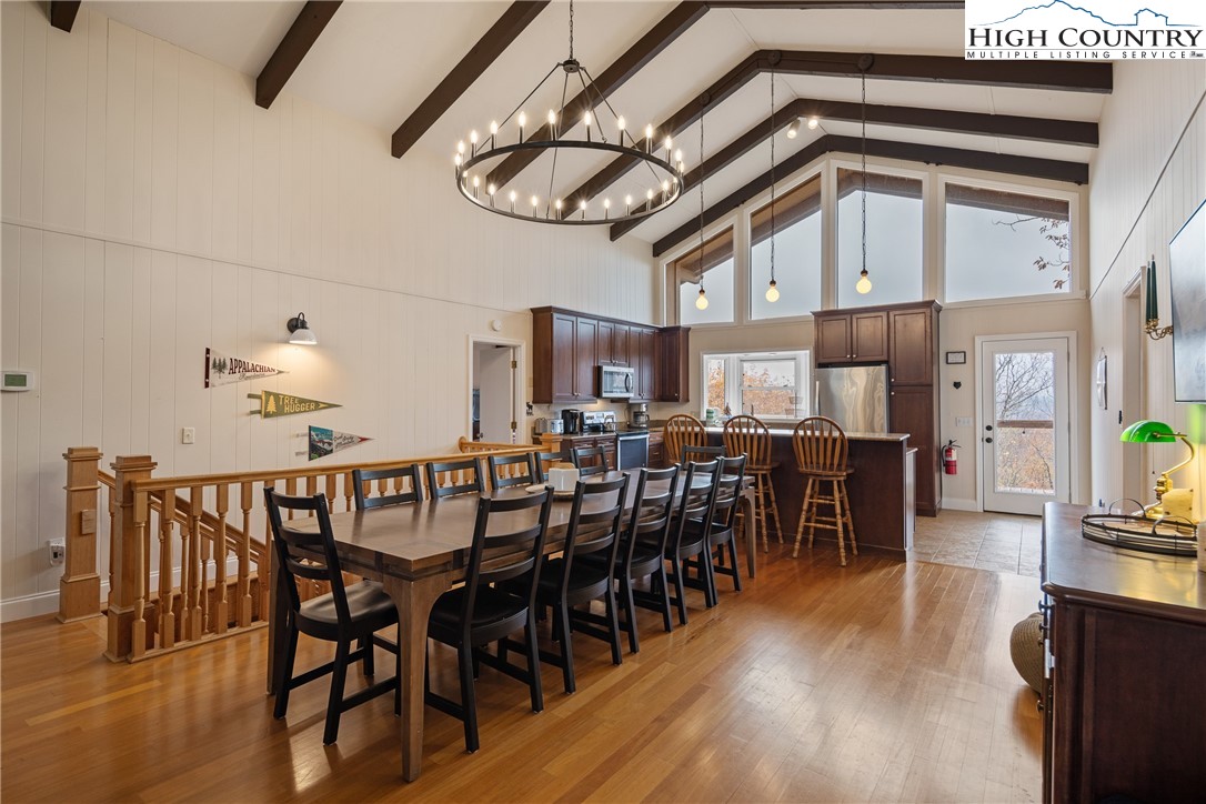501 St Andrews Road Beech Mountain, NC 28604 - Photo 8 of 46 a view of a dining room with furniture window and wooden floor