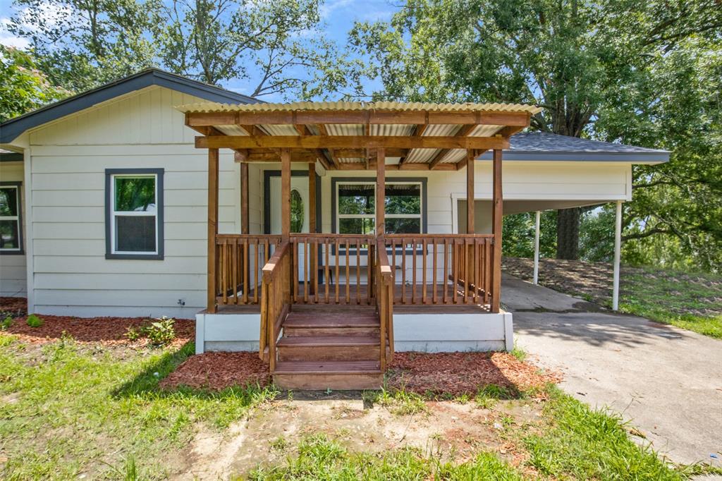 121 Circle Drive Bogata, TX 75417 - Photo 1 of 14 a front view of a house with a porch