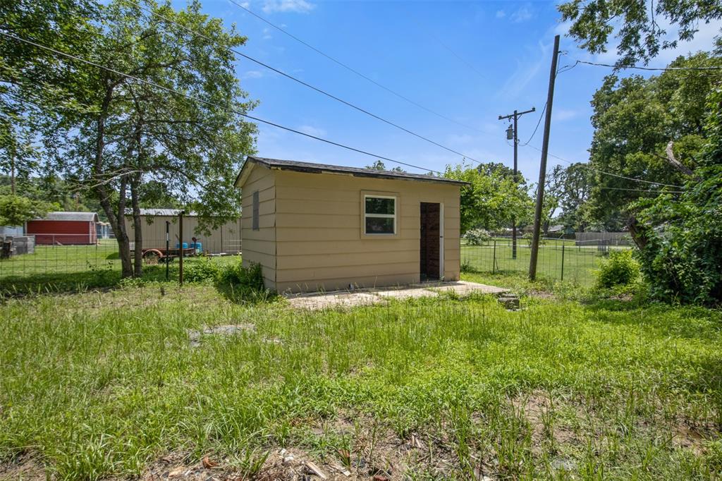 121 Circle Drive Bogata, TX 75417 - Photo 13 of 14 a view of a backyard with plants and large trees