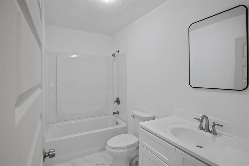 121 Circle Drive Bogata, TX 75417 - Photo 8 of 14 a bathroom with a sink a toilet and shower