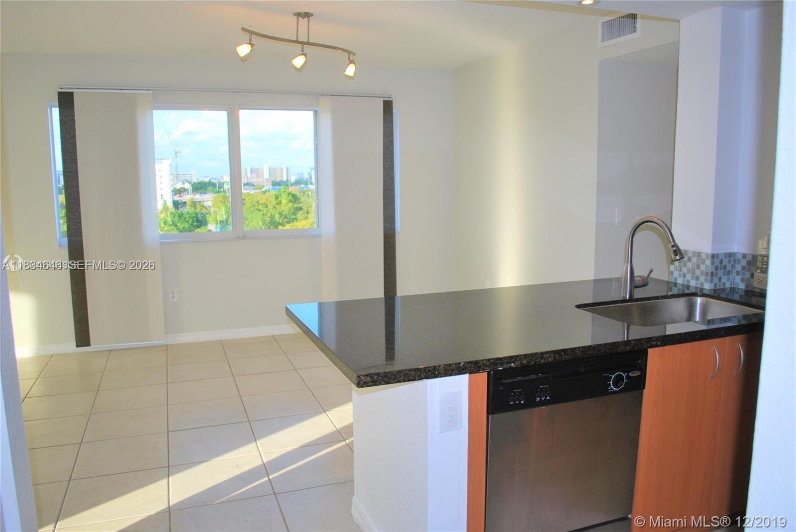 816 Northwest 11th Street, Unit 801 Miami, FL 33136 - Photo 14 of 51 a kitchen with stainless steel appliances granite countertop a sink and a granite counter tops