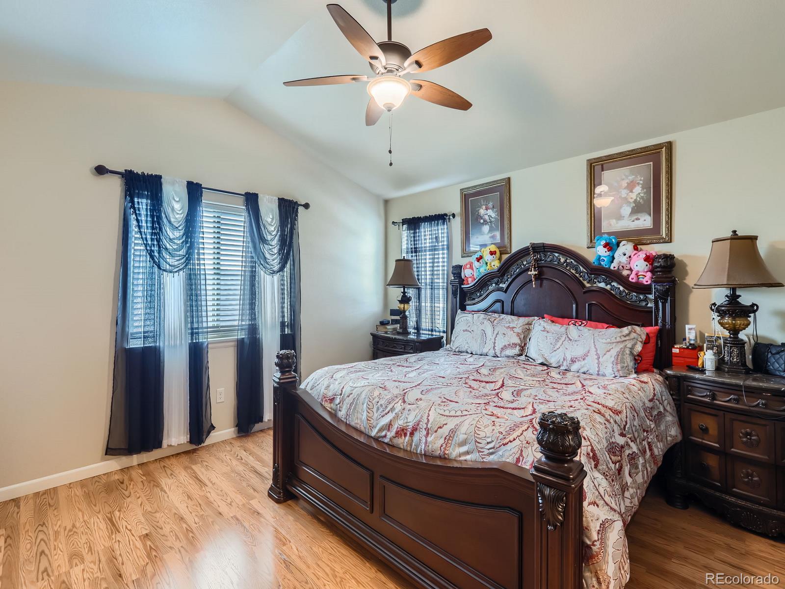 3505 Willow Drive Evans, CO 80620 - Photo 16 of 28 a bedroom with a bed and a chandelier