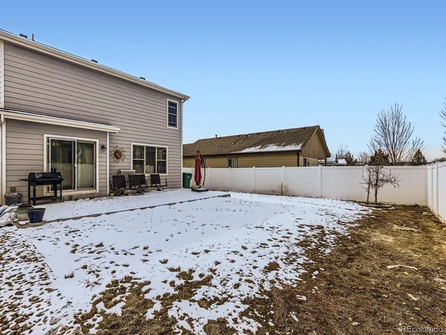 a wooden bench sitting in front of a house