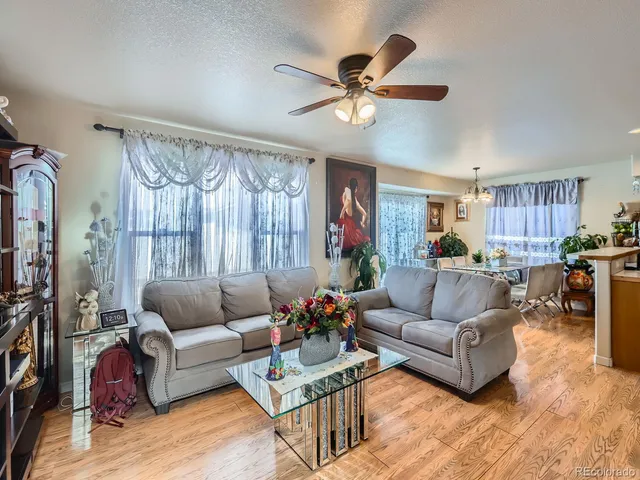 a living room with furniture and a chandelier