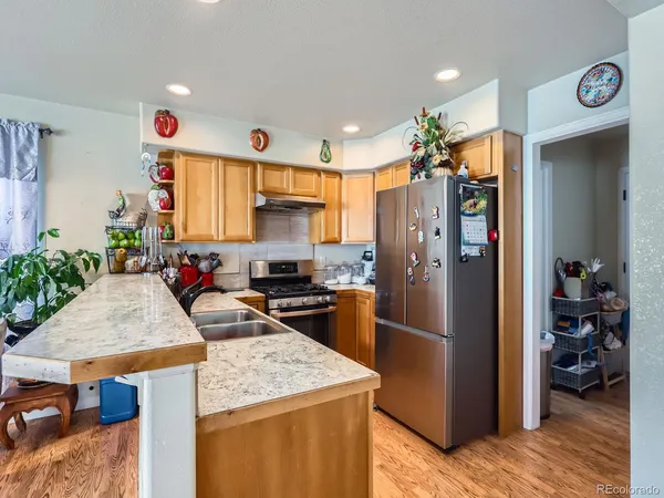 a kitchen with stainless steel appliances granite countertop a stove and a refrigerator
