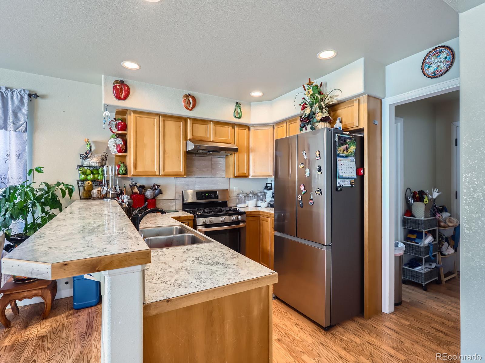 3505 Willow Drive Evans, CO 80620 - Photo 10 of 28 a kitchen with a refrigerator a stove and a sink