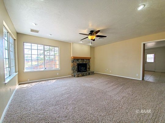 1037 South Ranger Street Ridgecrest, CA 93555 - Photo 19 of 26 an empty room with windows and fireplace