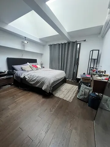 a bedroom with bed and a window