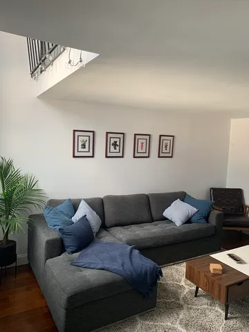 a living room with furniture and painting on the wall