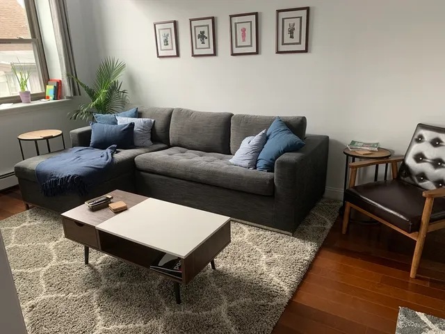 a living room with furniture and a rug
