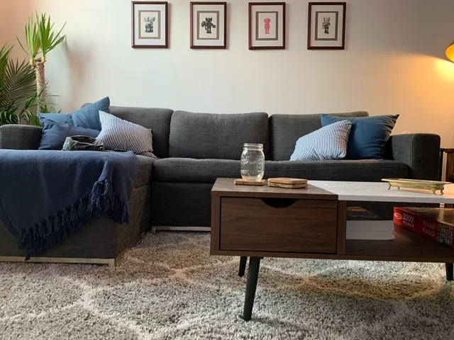 a living room with furniture and a rug