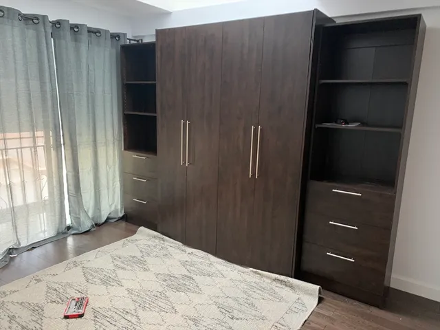 a bedroom with a bed and a window