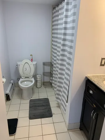 a bathroom with a toilet and a shower