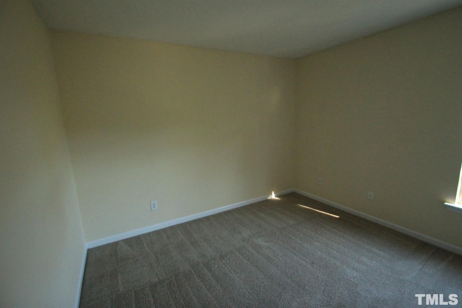 408 Pebblestone Drive Durham, NC 27703 - Photo 15 of 27 an empty room with a bench