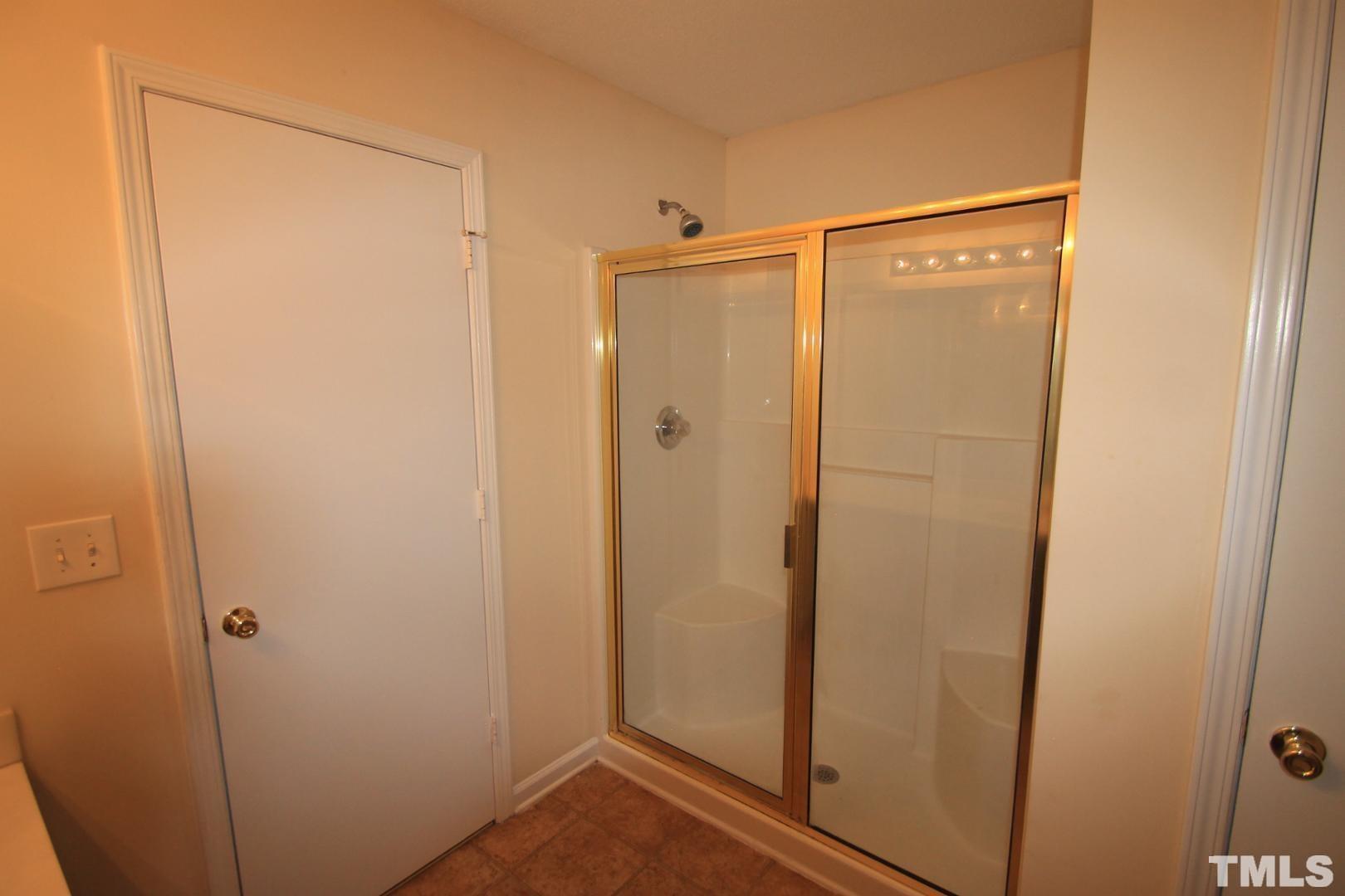 408 Pebblestone Drive Durham, NC 27703 - Photo 18 of 27 a bathroom with a glass shower door